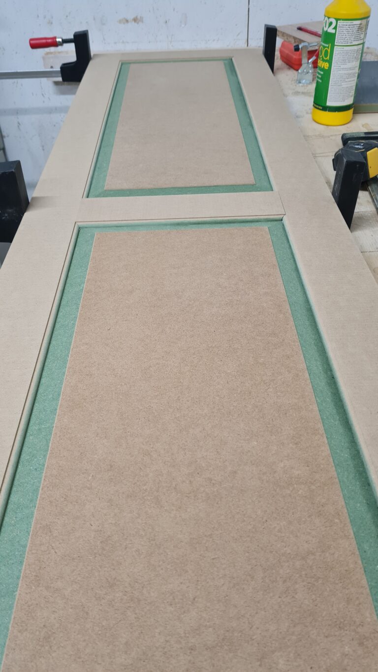 Dressing room cupboard door laid down with clamps
